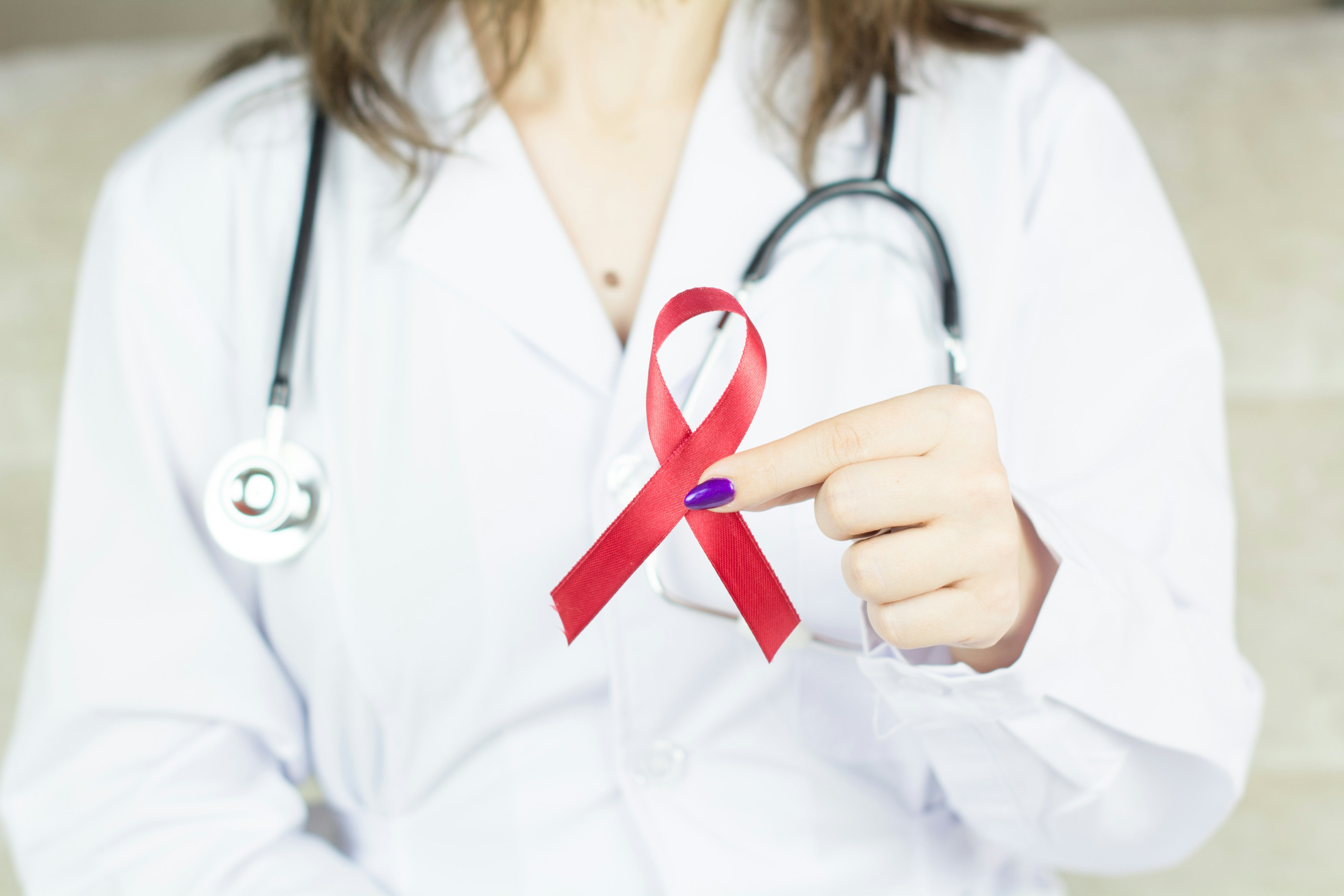 Doctor holding cancer ribbon